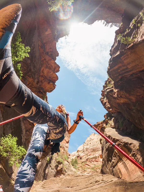 A female hiker in the Narrows (viewed from the ground) at Zion