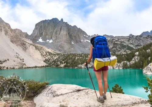 A woman backpacker admires the beauty of Big Pine Lakes