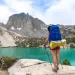 A woman backpacker admires the beauty of Big Pine Lakes