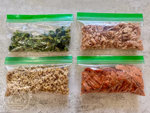 4 dinners of dehydrated meals packed in Ziploc snack size bags - How to Dehydrate Meals for Backpacking