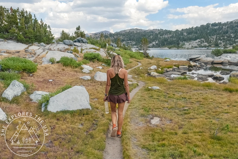 Labor Day Sale 2025 - a female hiker hikes along thousand island lake in the Sierra on labor day weekend