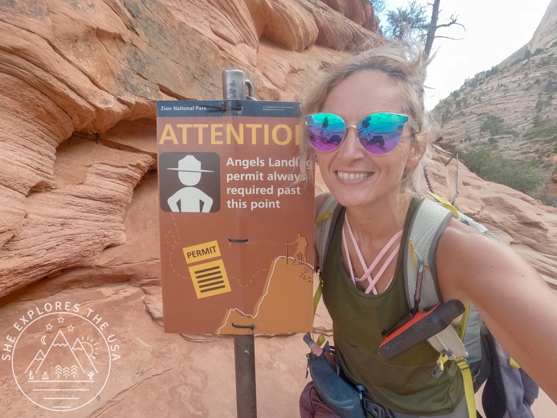 author taking a selfie with the permit required sign