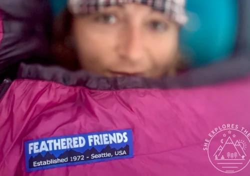 A woman is seen insider her Feathered Friends petrel 10 ul sleeping bag