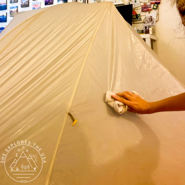 Applying Nikwax Tent and Gear SolarProof with a cloth to a Big Agnes rainfly indoors
