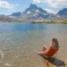 Patagonia Summer Sale 2025 - a female hiker sits in her REI flexlite air chair in thousand island lake in the Sierra