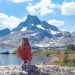 Relaxing in a backpacking chair with scenic mountain view, highlighting back comfort and lumbar support routine.